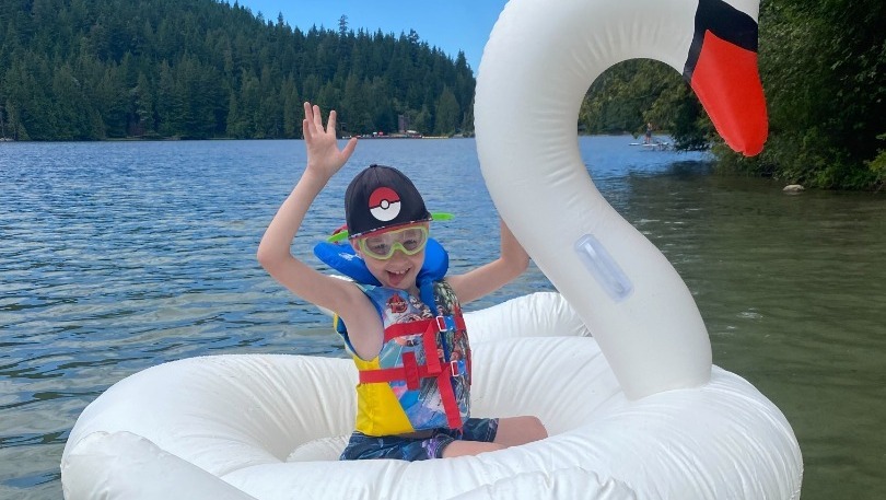 Kid having fun on a duck floatie