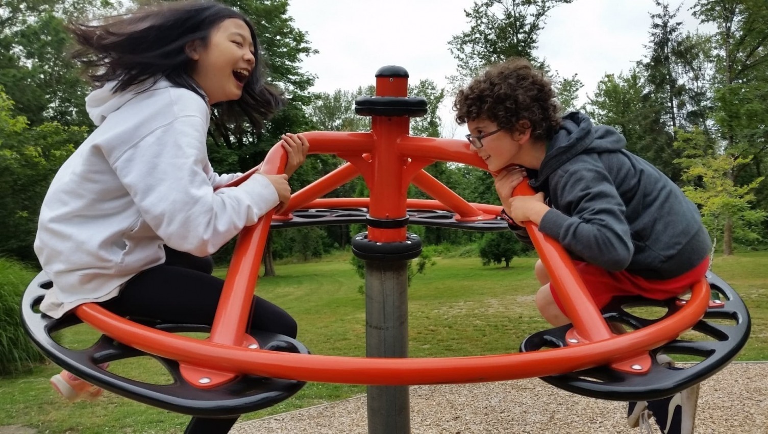 A girl and a boy having fun at the playground