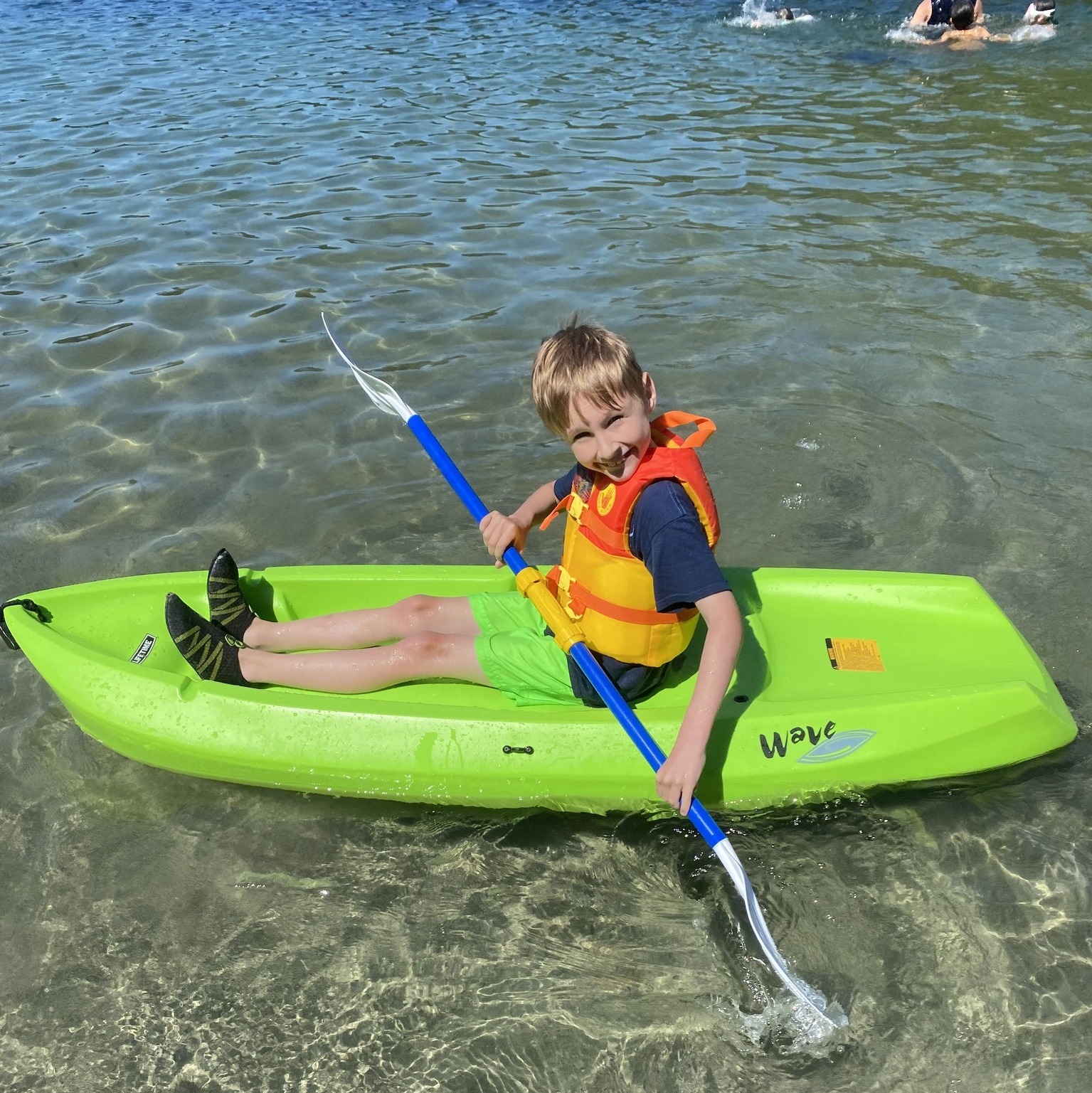 Kid getting ready to set sail on a kayak